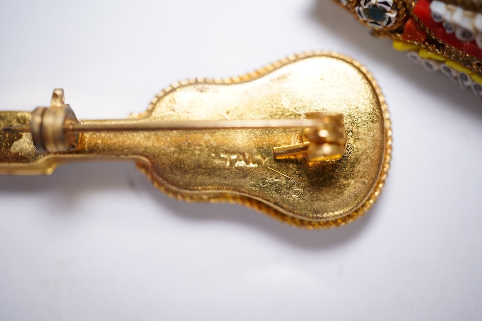 A collection of twenty-eight micro-mosaic brooches, including ten banjo and guitars shaped brooches, six similar large oval brooches, nine small brooches and three long brooches. (28) Condition - good